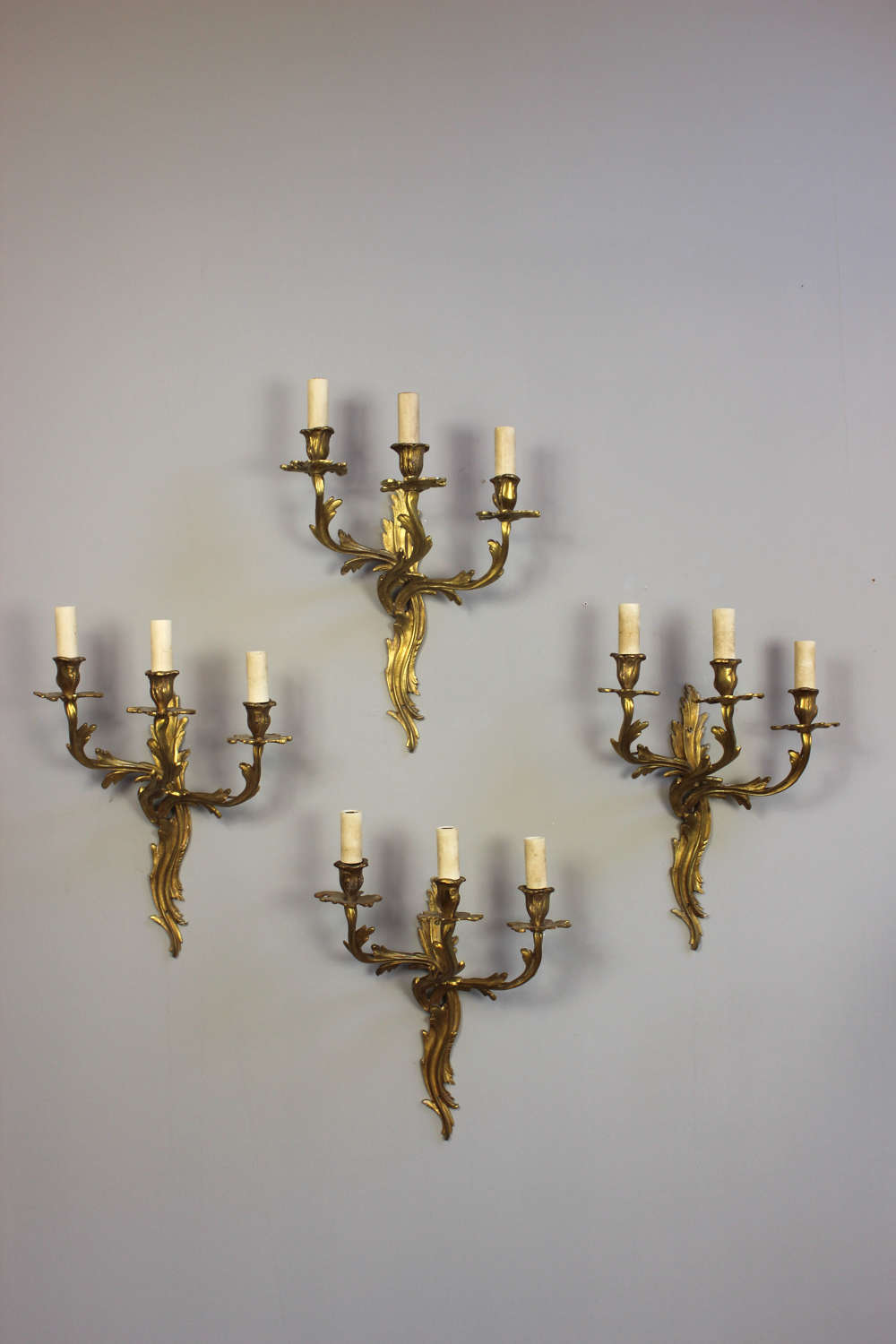Two pairs of English  gilded naturalistic three branch wall lights